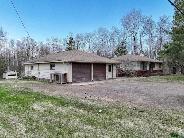 7113 E County Rd E, South Range, WI 54874 - view of front of property with a garage, a chimney, a front lawn, and an outdoor structure