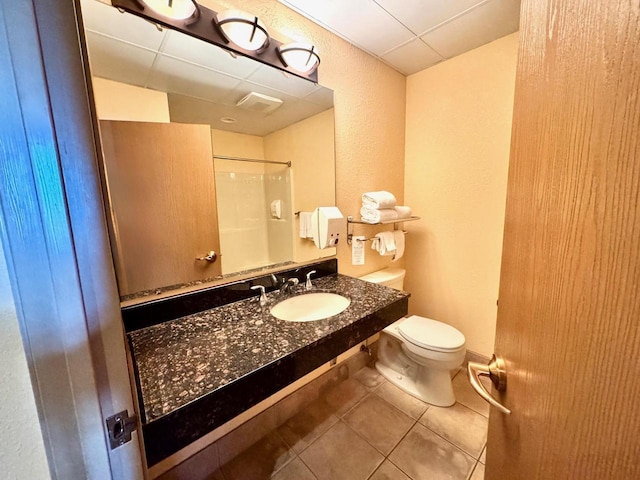 2504 River Rd Unit 7218, Wisconsin Dells, WI 53965 - bathroom with a shower, tile patterned floors, a sink, toilet, and a paneled ceiling
