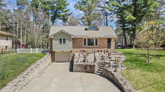 175 Old Wausau Rd, Stevens Point, WI 54481 - view of front of property featuring concrete driveway, a garage, metal roof, and a standing seam roof