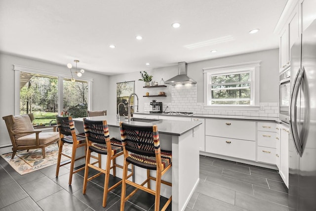 175 Old Wausau Rd, Stevens Point, WI 54481 - kitchen with wall chimney exhaust hood, a sink, backsplash, recessed lighting, and dark tile patterned floors