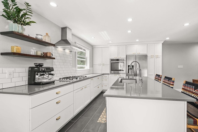 175 Old Wausau Rd, Stevens Point, WI 54481 - kitchen featuring stainless steel appliances, wall chimney exhaust hood, a sink, decorative backsplash, and recessed lighting