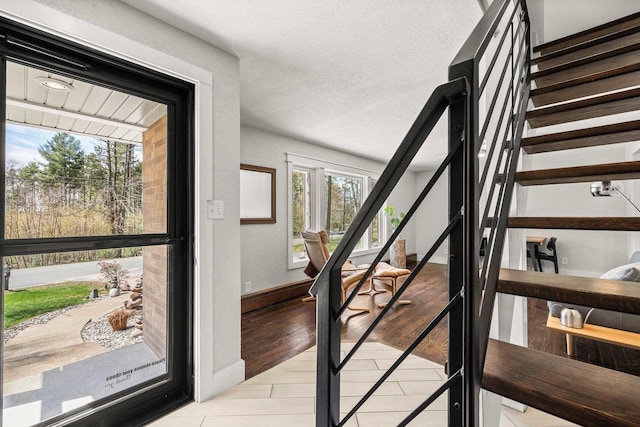 175 Old Wausau Rd, Stevens Point, WI 54481 - stairs with a textured ceiling and tile patterned flooring