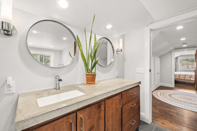 175 Old Wausau Rd, Stevens Point, WI 54481 - ensuite bathroom featuring vanity, lofted ceiling, recessed lighting, and wood finished floors