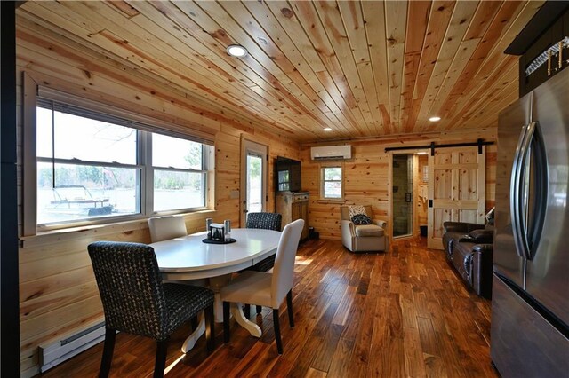 2097 Sunnyside Rd, Danbury, WI 54830 - dining room with a barn door, an AC wall unit, a baseboard radiator, dark wood-style flooring, and wooden walls