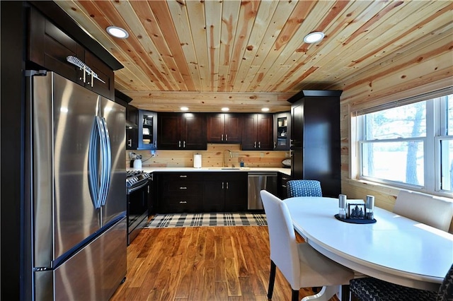2097 Sunnyside Rd, Danbury, WI 54830 - kitchen featuring stainless steel appliances, wood ceiling, recessed lighting, glass insert cabinets, and light countertops