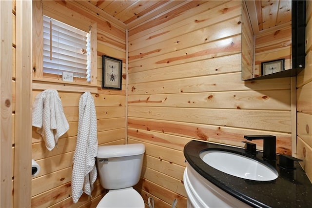2097 Sunnyside Rd, Danbury, WI 54830 - half bathroom with wood walls, toilet, vanity, and wooden ceiling