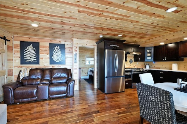 2097 Sunnyside Rd, Danbury, WI 54830 - kitchen with appliances with stainless steel finishes, under cabinet range hood, wood finished floors, open floor plan, and wooden walls