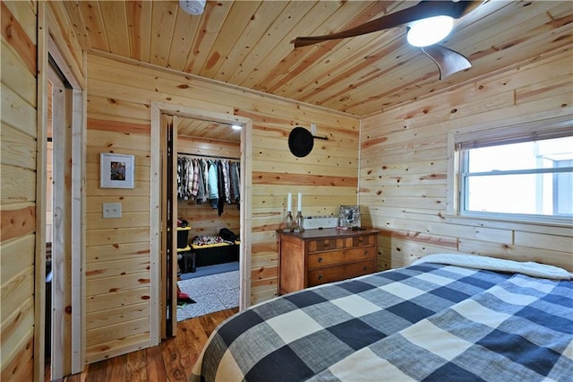 2097 Sunnyside Rd, Danbury, WI 54830 - bedroom featuring wood walls, wood ceiling, a closet, and wood finished floors