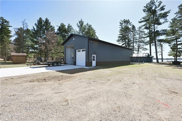 2097 Sunnyside Rd, Danbury, WI 54830 - view of home's exterior featuring an outdoor structure, a garage, and driveway