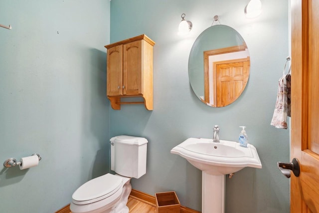 half bathroom featuring toilet