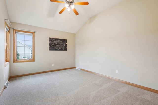 carpeted empty room with baseboards, ceiling fan, and vaulted ceiling