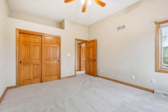 unfurnished bedroom featuring light carpet, baseboards, and a ceiling fan