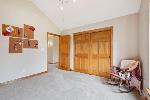unfurnished bedroom featuring carpet, vaulted ceiling, and baseboards