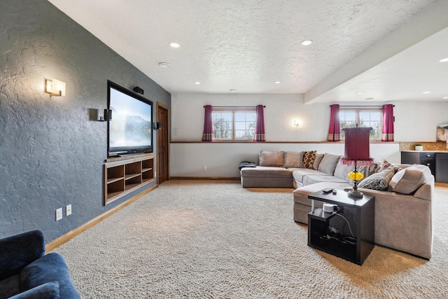 living room with carpet flooring, a textured wall, baseboards, recessed lighting, and a textured ceiling