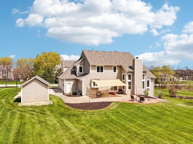 back of property with a patio, a garage, a yard, entry steps, and a chimney