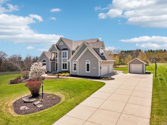 traditional-style home with a front yard, a garage, and an outbuilding