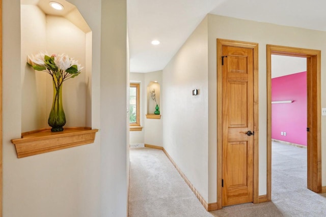 corridor with light colored carpet, baseboards, and recessed lighting
