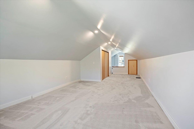 5425 Gettle Ave, Madison, WI 53705 - additional living space with vaulted ceiling, baseboards, and light carpet