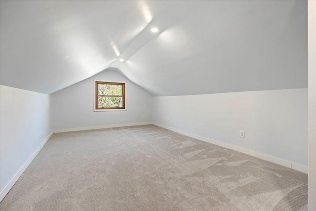 5425 Gettle Ave, Madison, WI 53705 - additional living space with light carpet, vaulted ceiling, and baseboards