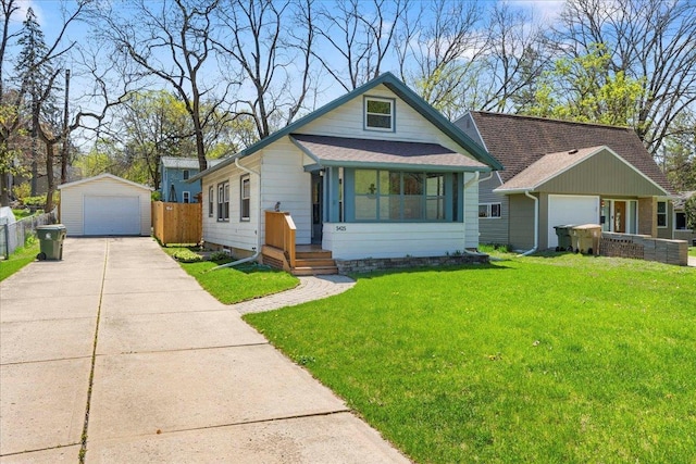 5425 Gettle Ave, Madison, WI 53705 - view of front facade with a garage, an outdoor structure, and roof with shingles