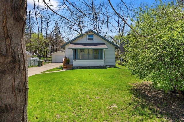 5425 Gettle Ave, Madison, WI 53705 - bungalow with an outdoor structure, a front lawn, and a garage