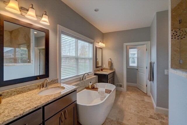 824 Richard Way, Waunakee, WI 53597 - full bath featuring a shower stall, baseboards, healthy amount of natural light, and a freestanding tub