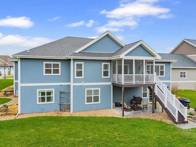 824 Richard Way, Waunakee, WI 53597 - rear view of house featuring a patio, a sunroom, a yard, roof with shingles, and stairs