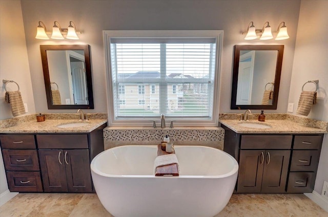 824 Richard Way, Waunakee, WI 53597 - bathroom featuring a freestanding bath, two vanities, and baseboards