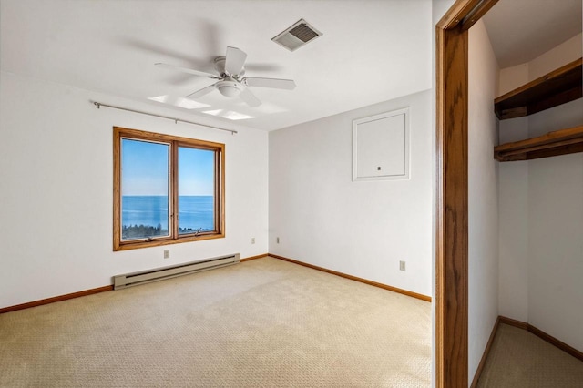 unfurnished bedroom with a baseboard radiator, light carpet, baseboards, and a ceiling fan