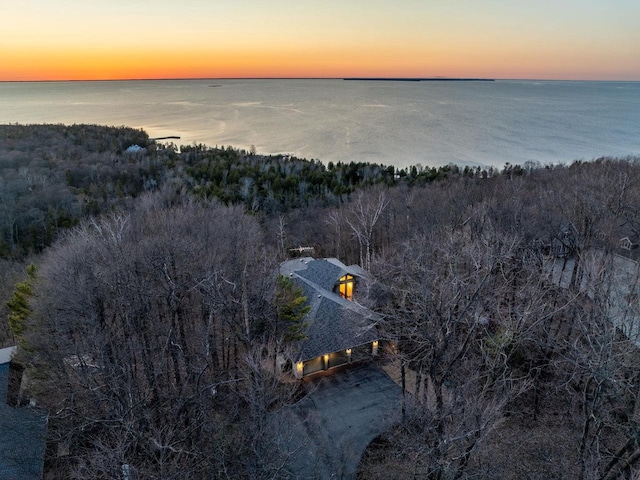aerial view of property and surrounding area featuring a nearby body of water