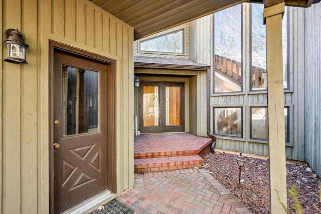 view of exterior entry with board and batten siding
