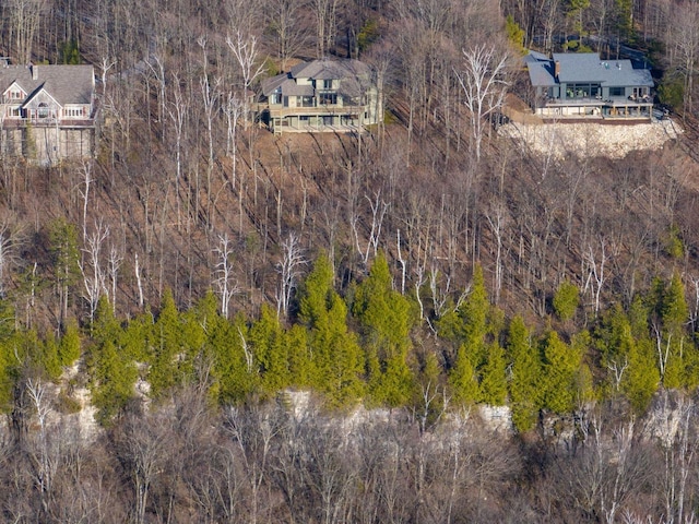 view from above of property with a heavily wooded area