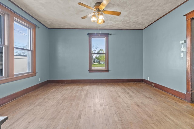 210 E Walworth St, Elkhorn, WI 53121 - empty room featuring hardwood / wood-style floors, ceiling fan, baseboards, and a textured ceiling