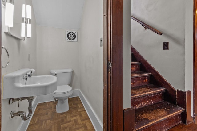 210 E Walworth St, Elkhorn, WI 53121 - half bath with toilet, baseboards, vaulted ceiling, and a sink