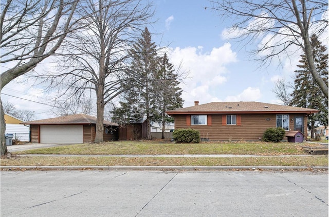 5803 N 77th St, Milwaukee, WI 53218 - ranch-style house with an outdoor structure, a chimney, driveway, a front yard, and an attached garage