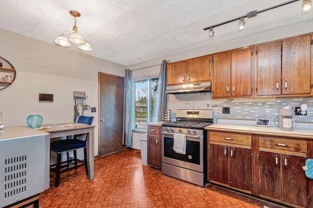 5803 N 77th St, Milwaukee, WI 53218 - kitchen featuring stainless steel gas range oven, under cabinet range hood, light countertops, backsplash, and a chandelier