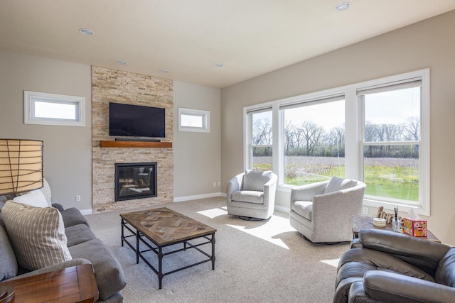 living room featuring carpet floors, a stone fireplace, baseboards, and recessed lighting