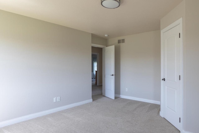 unfurnished bedroom with light carpet and baseboards