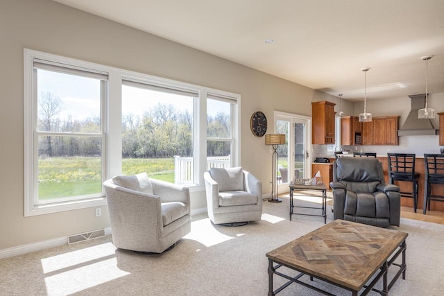 living room with light carpet and baseboards