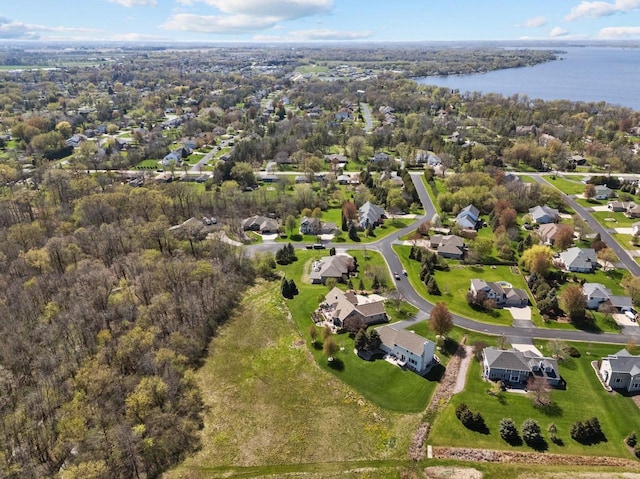 aerial view of property's location featuring a large body of water and nearby suburban area