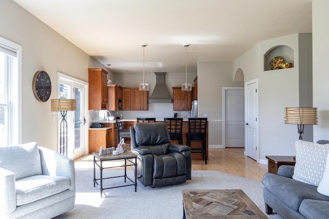 living room with healthy amount of natural light and light carpet