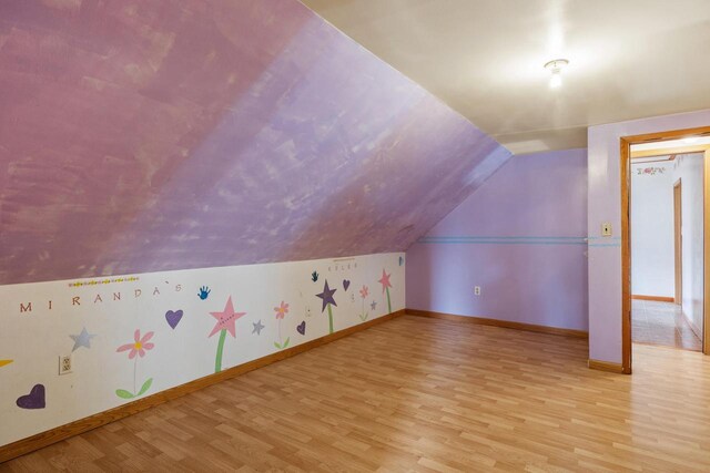 1214 S 17th St, Sheboygan, WI 53081 - additional living space featuring light wood-type flooring, vaulted ceiling, and baseboards