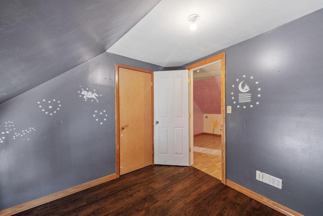 1214 S 17th St, Sheboygan, WI 53081 - unfurnished bedroom featuring wood finished floors, vaulted ceiling, and baseboards