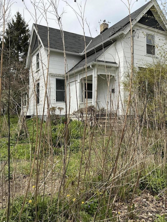 W59N367 Hilbert Ave, Cedarburg, WI 53012 - view of property exterior featuring a chimney and roof with shingles