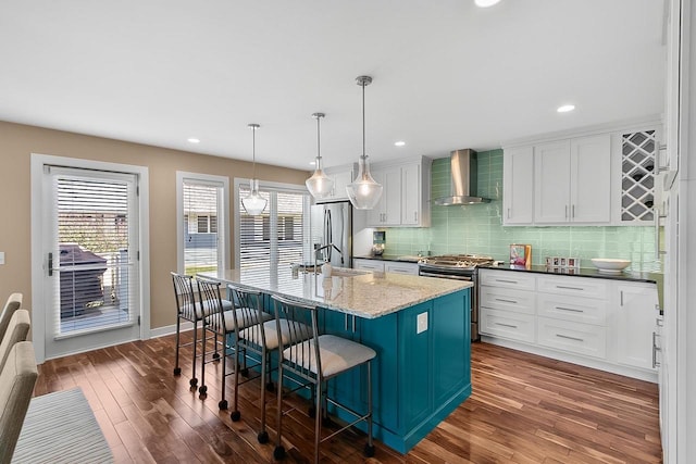 W11055 Eagle Dr, Lodi, WI 53555 - kitchen with wall chimney exhaust hood, appliances with stainless steel finishes, a sink, dark wood-style floors, and white cabinets