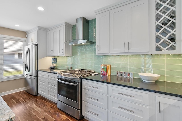 W11055 Eagle Dr, Lodi, WI 53555 - kitchen featuring wall chimney exhaust hood, stainless steel appliances, white cabinetry, dark countertops, and decorative backsplash