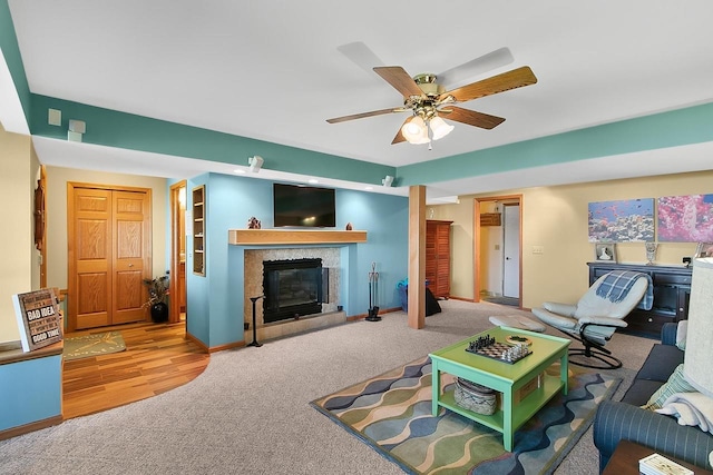 W11055 Eagle Dr, Lodi, WI 53555 - carpeted living room with a tiled fireplace, ceiling fan, and baseboards