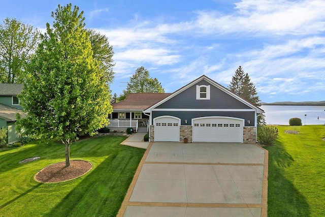 W11055 Eagle Dr, Lodi, WI 53555 - view of front of house with stone siding, a garage, a front yard, concrete driveway, and covered porch