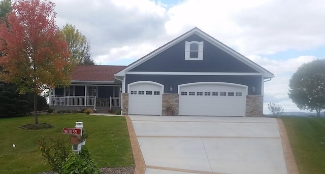 W11055 Eagle Dr, Lodi, WI 53555 - view of front facade featuring an attached garage, concrete driveway, a front yard, stone siding, and a porch