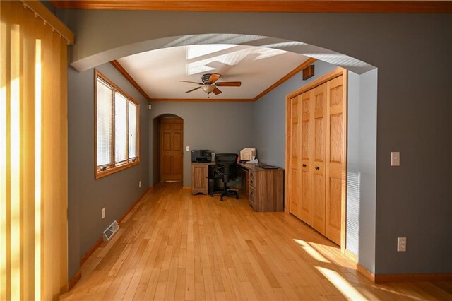 W5937 Ross Rd, Trego, WI 54888 - unfurnished office featuring arched walkways, ornamental molding, a ceiling fan, light wood-style floors, and baseboards